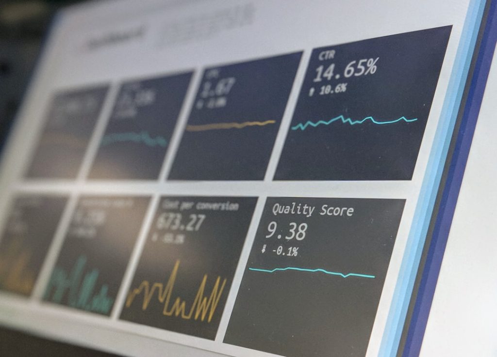 Data reporting dashboard displaying CTR, quality score and performance metrics on a screen, representing AI SEO tool analytics