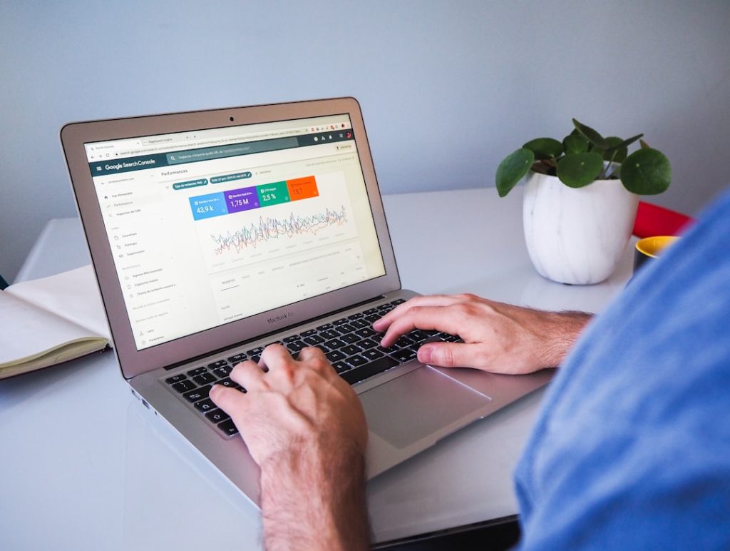 Digital marketer working on a laptop showing Google Search Console data, choosing the right SEO strategy and tools